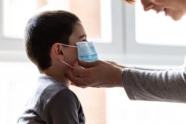 Una madre coloca a su hijo una mascarilla, en Vitoria/Euskadi (España) a 19 de abril de 2020.