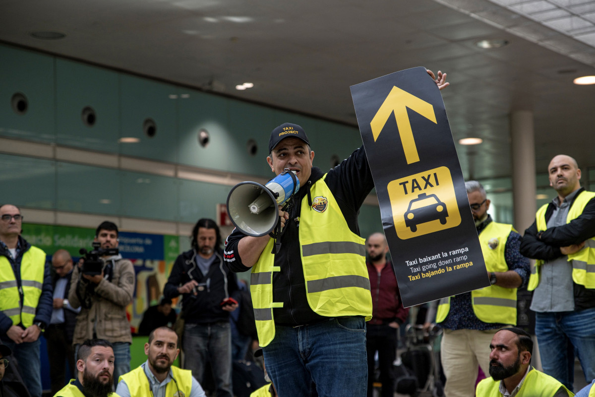 El portavoz de Élite Taxi, Tito Álvarez, sujeta un megáfono durante una concentración de taxi en la T1 del aeropuerto de Barcelona, a 17 de abril de 2023, en Barcelona, Catalunya (España).