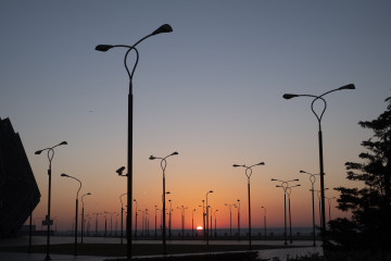 Park side with stands projectors against blue sky