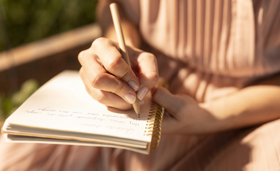 Close up hand writing notebook