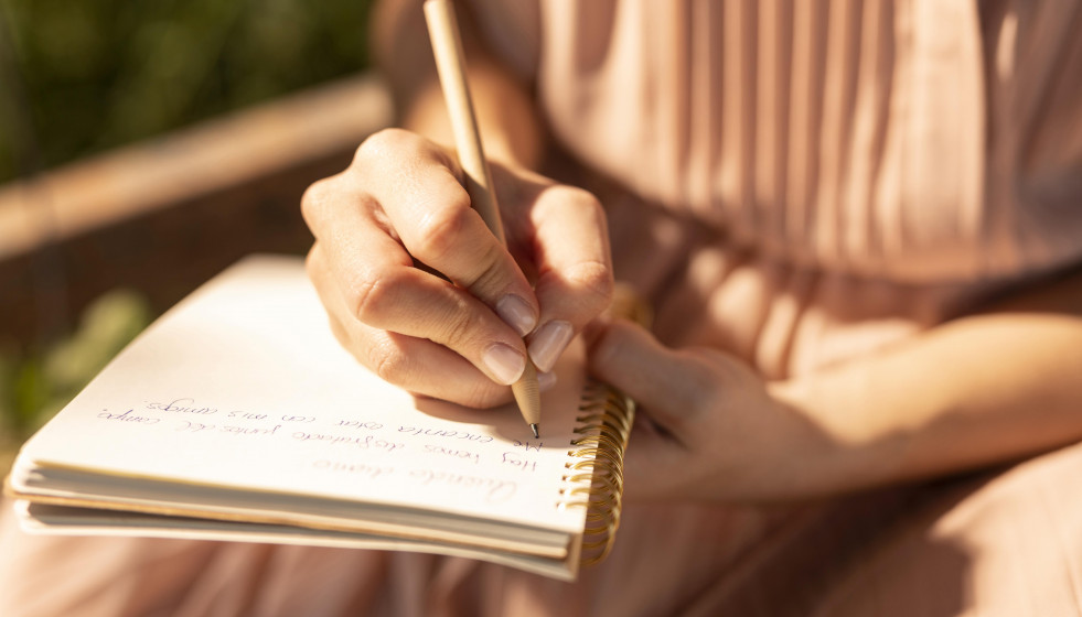 Close up hand writing notebook