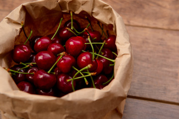Cherries craft paper package wooden table
